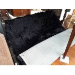 A black fluffy rug