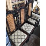 A set of 5 oak framed and bergere back chairs