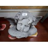 A concrete garden cherub