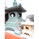 A large stone pagoda garden ornament and a terracotta small pagoda ornament