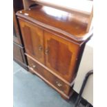 A reproduction yew wood tv cabinet