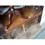 A walnut coffee table with drawer