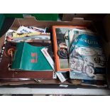 A box of motorcycle books and ephemera