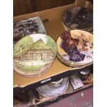 A box of decorative plates including dogs