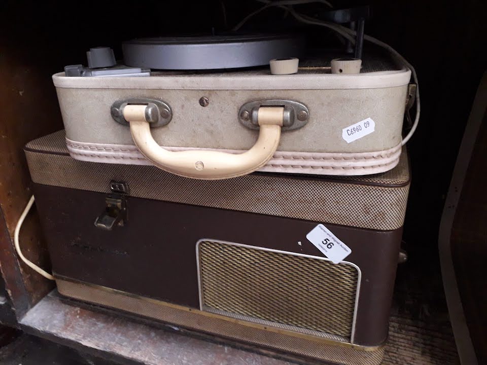 A vintage record player and a reel to reel tape player