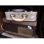 A vintage record player and a reel to reel tape player
