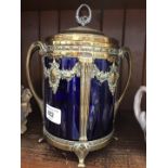 A WMF silver plated biscuit jar with Classical style moulding and blue glass liner.