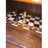 An ebonised and boxwood chess set with bone and hardwood board.