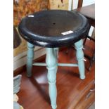 An old painted milking stool