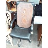 A black faux leather swivel office chair