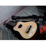 A Berkeley child's guitar withe music stand and a microphone