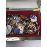 A box of vintage pin badges