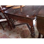 An oak drawer leaf table with twist legs