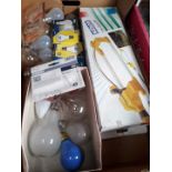 A box containing a mirror, garden sprinkler and light bulbs