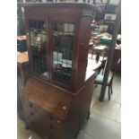 A mahogany bureau bookcase with leaded glass bookcase top