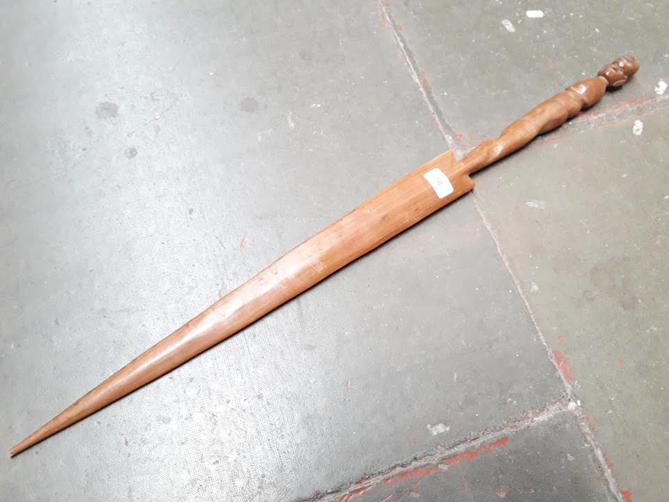 A wooden carved ornamental sword