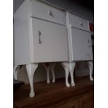 A pair of white painted bedside cabinets