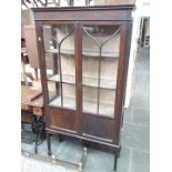 An Edwardian mahogany glazed bookcase on legs