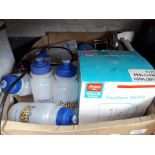 A box of water bottles, kettle, gas stove