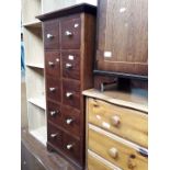 A modern multi drawer unit and a mahogany cupboard