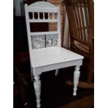 A white painted hall chair with tile back