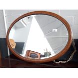 An oval inlaid framed mirror