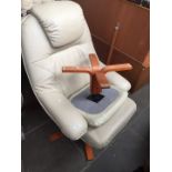 A cream Leather armchair and footstool