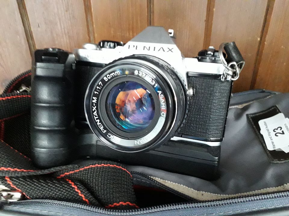 A camera bag with Pentax ME camera and 2 lenses