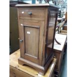 A mahogany bedside cupboard