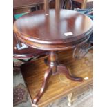 A mahogany tripod table