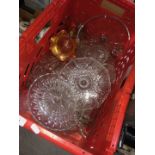 A red crate of pressed glass and crystal