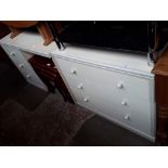 A chest of drawers and matching dressing table