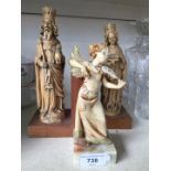 Pair of imitation ivory book ends and another figure