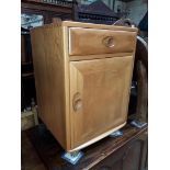 An Ercol blonde elm bedside cabinet, height 68cm.