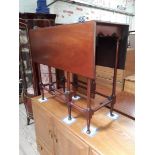 An Edwardian mahogany Sutherland table with turned stretchers.