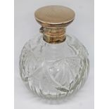 A hallmarked silver top and cut glass scent bottle with glass stopper, height 13cm.