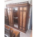 A Victorian Aesthetic style ebonised and walnut bedroom suite comprising wardrobe, dressing table,