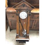 A double weight driven walnut and ebonised Vienna wall clock with architectural top, fluted and