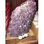 A geode rock on stand - possibly amethyst.