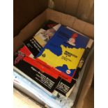 A box of football programmes and sheets.