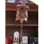 A cuckoo clock and 2 other clocks