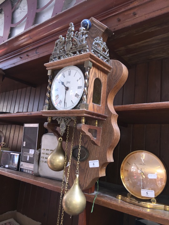 A reproduction Dutch style wall clock with weights.