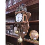 A reproduction Dutch style wall clock with weights.