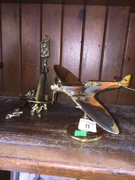 A group of collectable brass items to include a flying Spitfire on base, a set of brass large keys