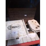 A wicker basket containing cookery books along with a set of porcelain and cast iron scales with