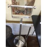 A deco style chrome toilet roll stand