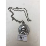 A white metal chain having pendant bearing William Shakespeare portrait.