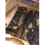 A basket of vintage tools, many made of ebony and brass.