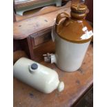A stoneware decanter and bed warmer
