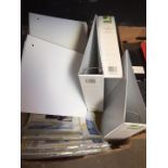 A box containing loose leaf binders and laminator pouches